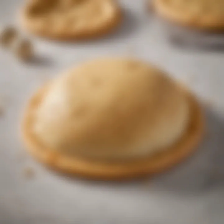 Golden gluten-free pizza dough ball resting on a marble surface