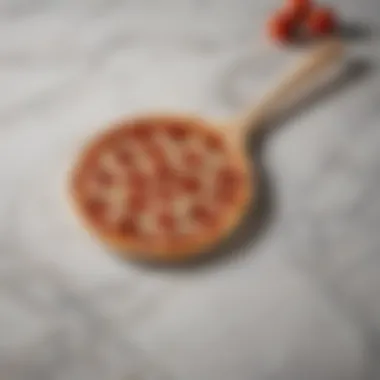 Elegant wooden small pizza paddle resting on marble surface