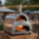 A sleek, modern mobile pizza oven set up at an outdoor event