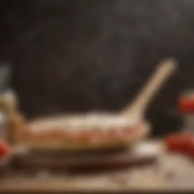 Wooden pizza peel with flour and dough