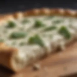 A close-up of a slice of white pizza topped with ricotta and herbs